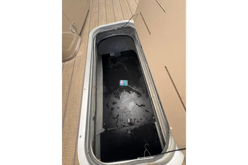 Slide: The Image of Open storage compartment on 2019 Bennington 25 QSBA boat, showing interior details. - 17