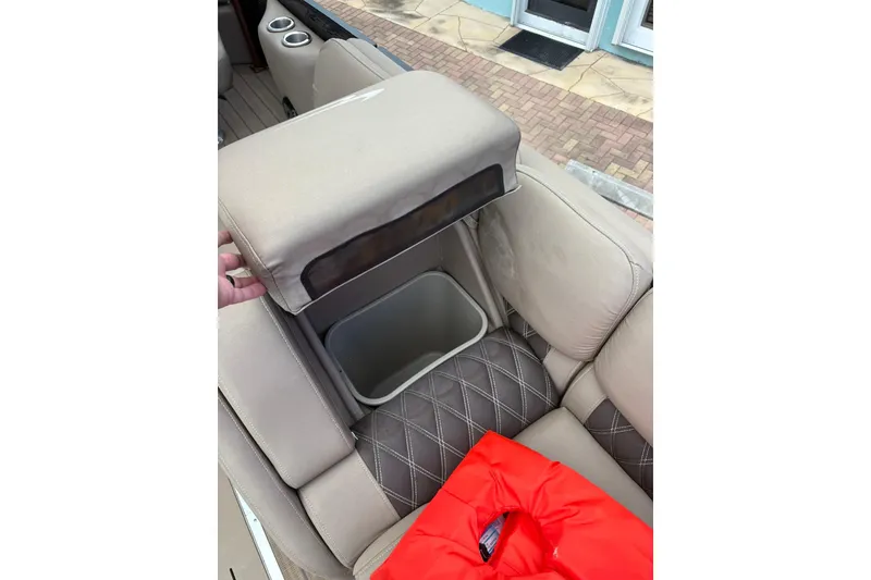 Slide: The Image of 2019 Bennington 25 QSBA boat interior with storage compartment and life jacket. - 7