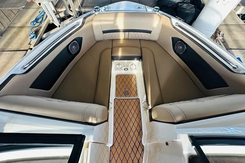 Slide: The Image of 2017 Sea Ray SLX-W 230 boat interior with tan seating and wood-patterned flooring. - 10