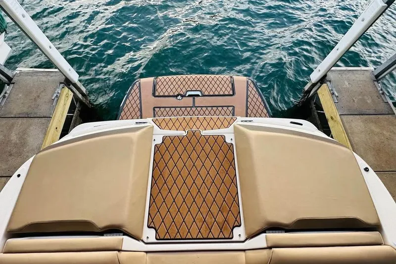 Slide: The Image of 2017 Sea Ray SLX-W 230 boat with teak deck, docked by water. - 6