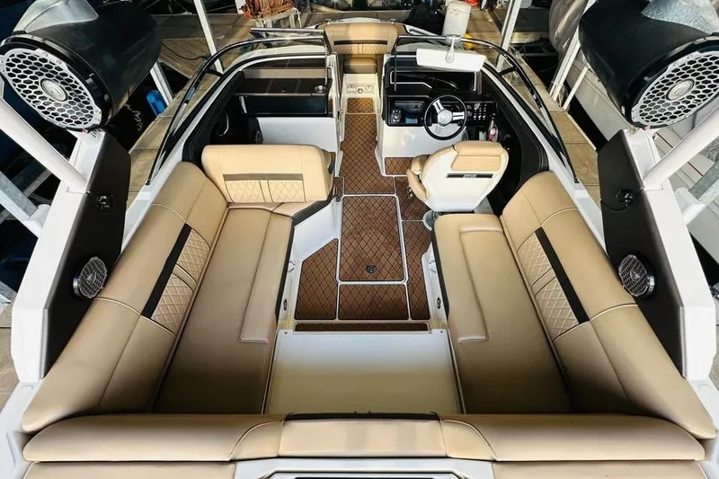 Slide: The Image of 2017 Sea Ray SLX-W 230 boat interior with beige seating and modern dashboard. - 8
