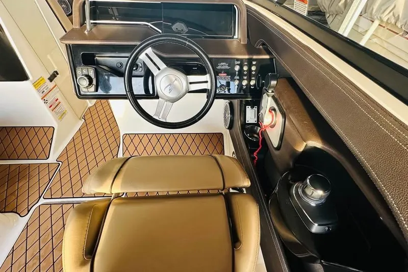 Slide: The Image of 2017 Sea Ray SLX-W 230 boat interior with steering wheel and control panel. - 9