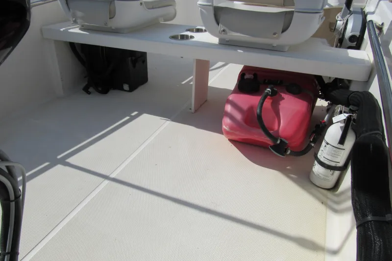 Slide: The Image of 2021 Boston Whaler 130 Super Sport with Mercury outboard engine, parked outdoors. - 11