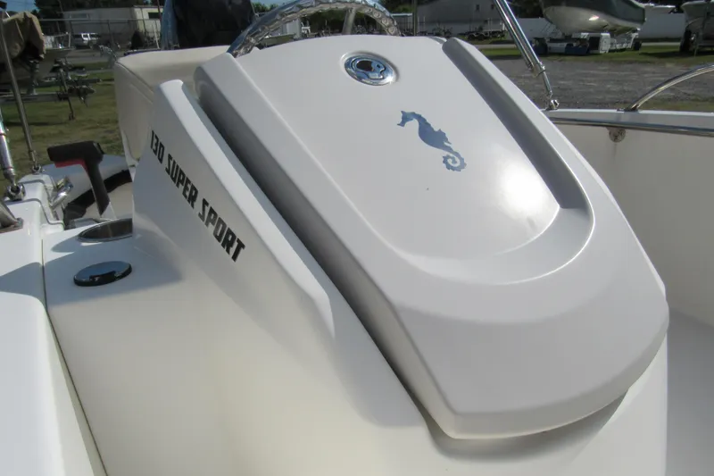 Slide: The Image of 2021 Boston Whaler 130 Super Sport boat interior with cushioned seating. - 13
