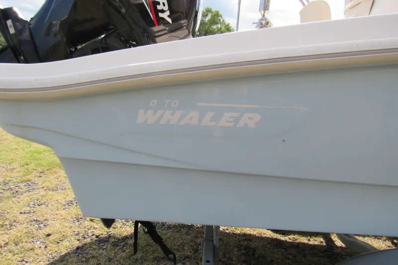 Slide: The Image of 2021 Boston Whaler 130 Super Sport boat console with seahorse emblem. - 14