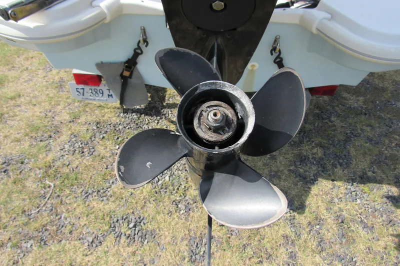 Slide: The Image of 2021 Boston Whaler 130 Super Sport on trailer, parked on grassy area under blue sky. - 3