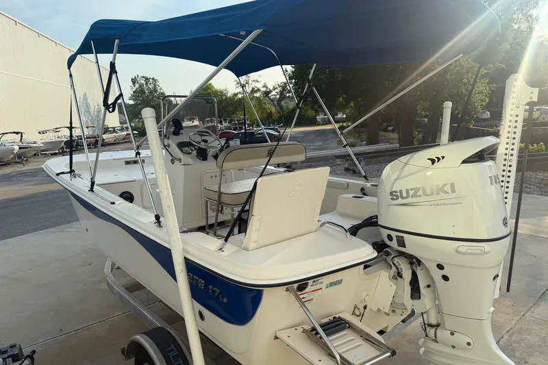 Slide: The Image of 2022 Carolina Skiff 17 LS boat with Suzuki outboard motor and blue canopy. - 4