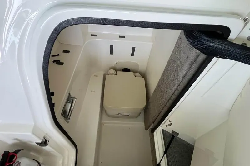 Slide: The Image of Interior of 2008 Sea Ray 250 SLX boat showing compact bathroom area. - 10