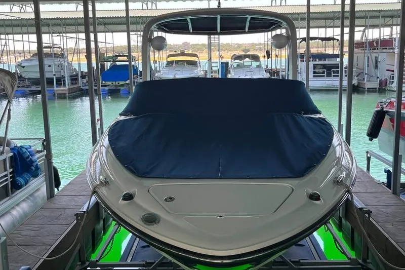 Slide: The Image of 2008 Sea Ray 250 SLX boat docked in a marina, covered and ready for use. - 6
