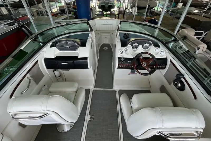 Slide: The Image of 2008 Sea Ray 250 SLX boat interior with dual helm seats and dashboard controls. - 7