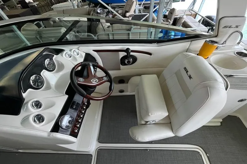 Slide: The Image of 2008 Sea Ray 250 SLX boat interior with steering wheel and seating. - 9