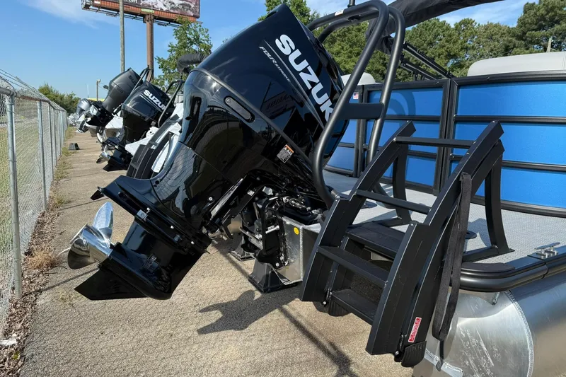 Slide: The Image of 2025 Bentley Pontoons Legacy 243 Navigator with Suzuki outboard motor, docked on a sunny day. - 4
