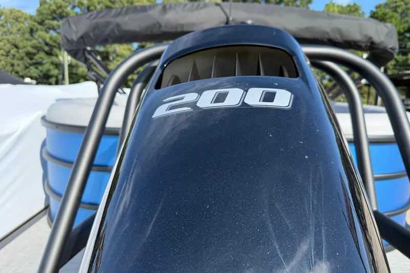 Slide: The Image of 2025 Bentley Pontoons Legacy 243 Navigator, close-up of engine cover with "200" marking. - 5