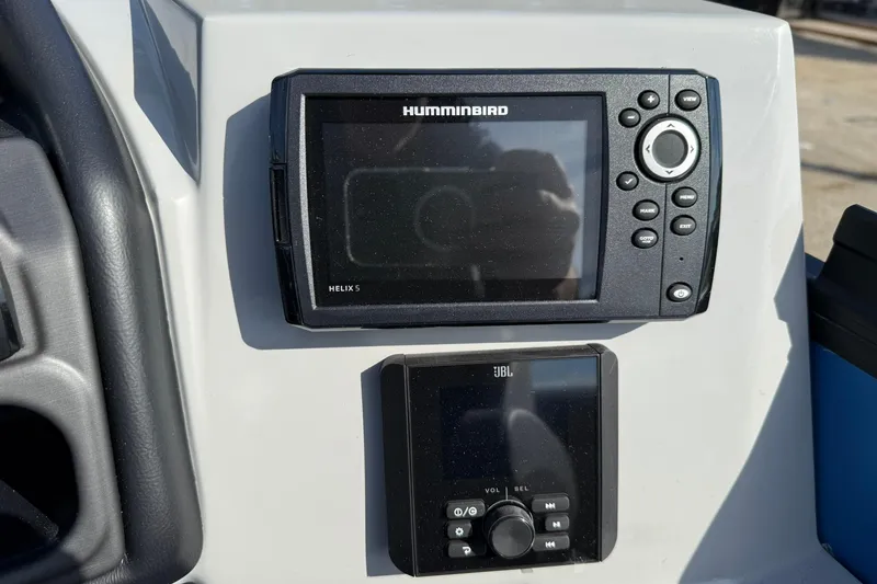 Slide: The Image of 2025 Bentley Pontoons Legacy 243 Navigator dashboard with Humminbird Helix 5 and JBL controls. - 9