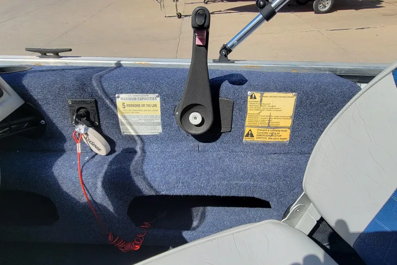 Slide: The Image of 1997 Sea Nymph 168 DLX boat interior with blue carpet and storage compartments. - 13