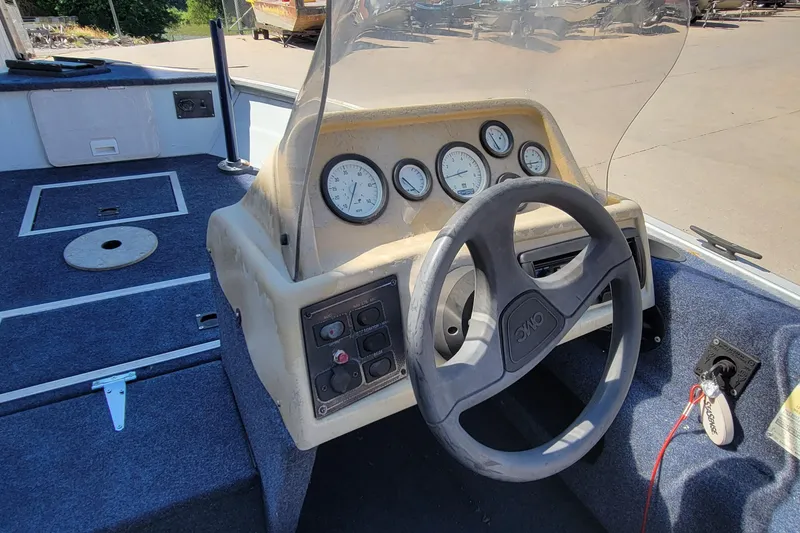 Slide: The Image of 1997 Sea Nymph 168 DLX boat interior with blue seating and storage compartments. - 14