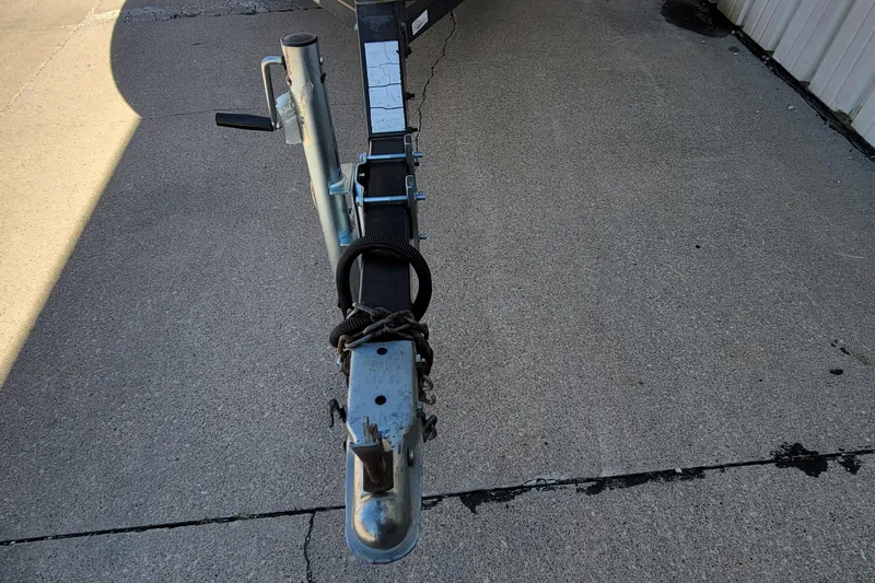 Slide: The Image of 1997 Sea Nymph 168 DLX boat with blue interior, docked beside a building. - 4