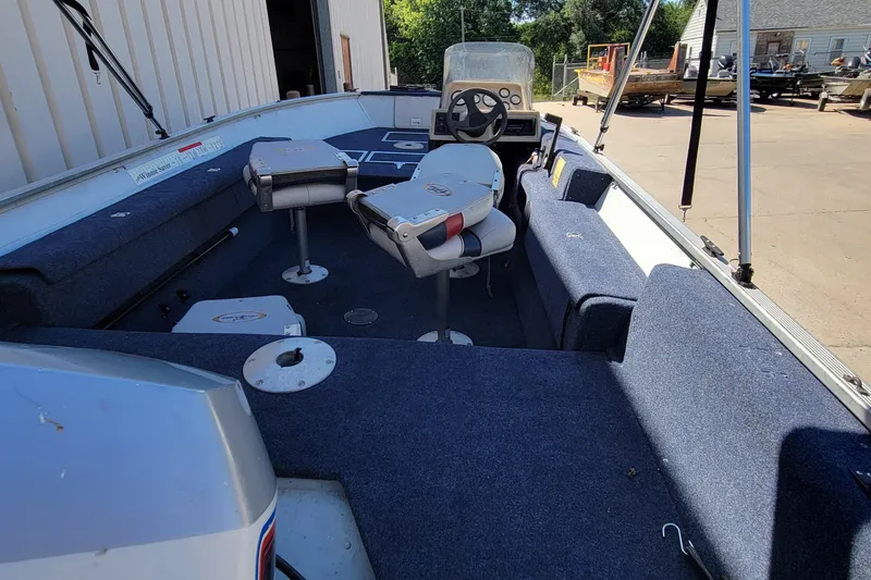 Slide: The Image of 1997 Sea Nymph 168 DLX boat on trailer, blue and white design, parked outdoors. - 5