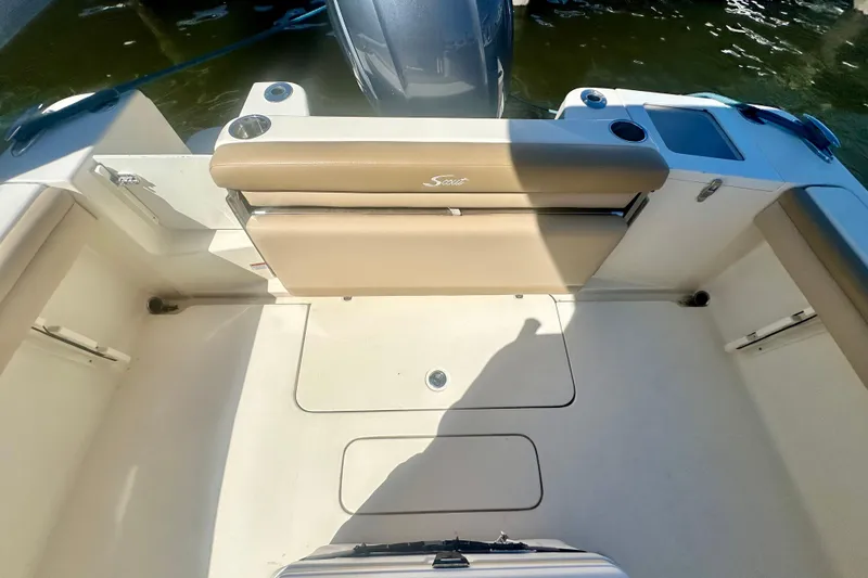 Slide: The Image of 2020 Scout 215 XSF boat interior with tan seating and storage compartments. - 2