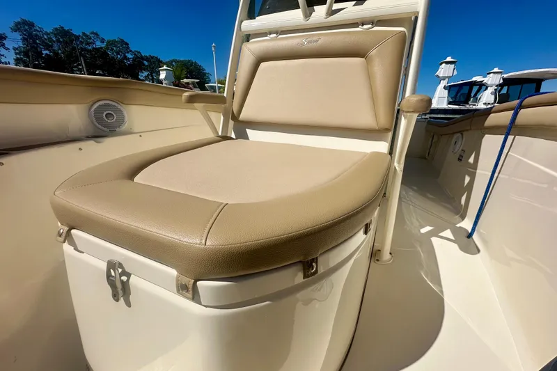 Slide: The Image of 2020 Scout 215 XSF boat seat with beige upholstery and storage compartment. - 5