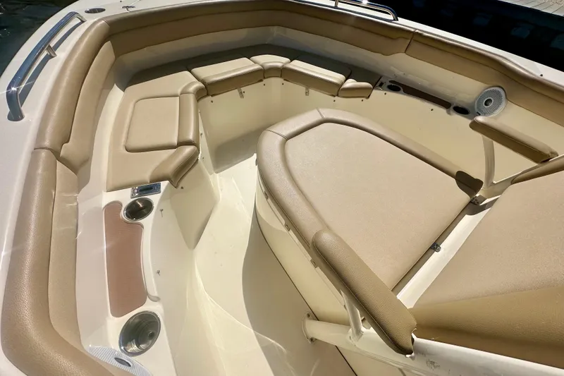 Slide: The Image of 2020 Scout 215 XSF boat interior with beige cushioned seating and cup holders. - 6
