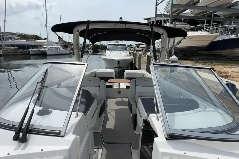 Slide: The Image of 2016 Regal 2700 ES Bowrider docked at marina, showcasing sleek design and spacious interior. - 4