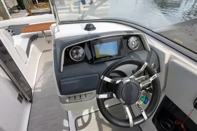 Slide: The Image of 2016 Regal 2700 ES Bowrider dashboard with steering wheel and navigation display. - 5