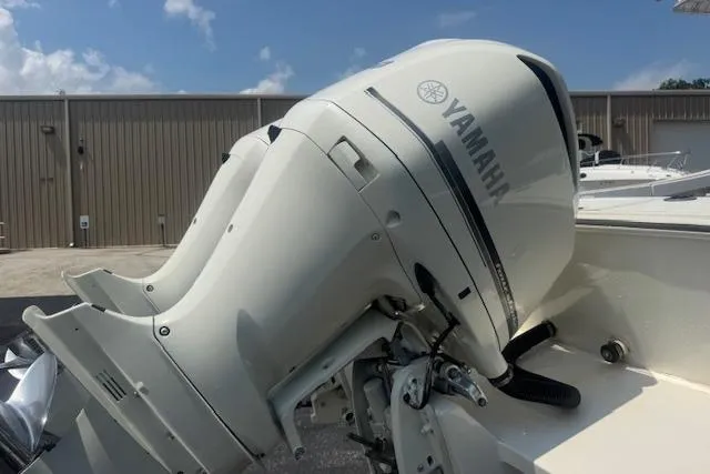 Slide: The Image of 1992 Mako 261B boat with Yamaha outboard motor, parked outdoors. - 10