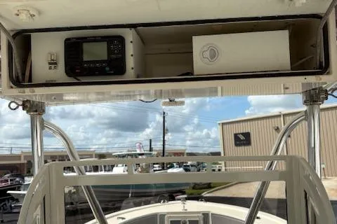 Slide: The Image of 1992 Mako 261B boat console with electronic equipment and storage compartment. - 12