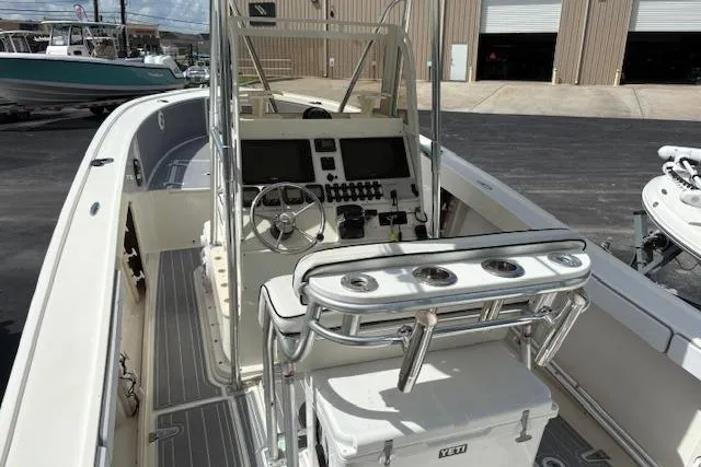 Slide: The Image of 1992 Mako 261B boat with modern console, steering wheel, and rod holders. - 15