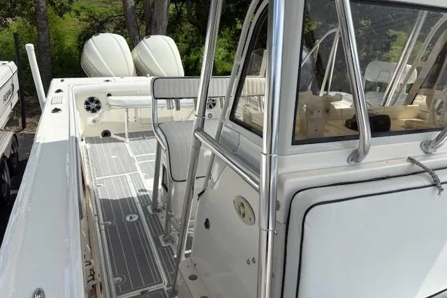 Slide: The Image of 1992 Mako 261B boat interior with dual engines and seating, featuring sleek design and modern amenities. - 17