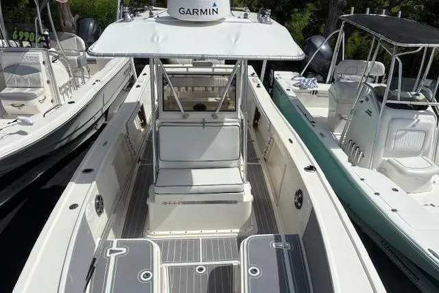 Slide: The Image of 1992 Mako 261B boat with Garmin equipment, docked among other vessels. - 20