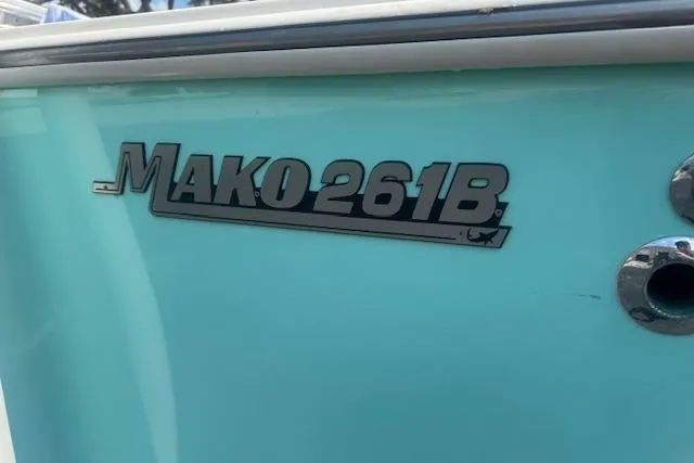 Slide: The Image of 1992 Mako 261B boat logo on light blue hull. - 5