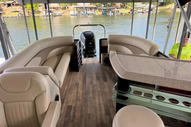 Slide: The Image of Luxurious 2017 Crest II 250 SLE pontoon boat interior with plush seating and scenic lake view. - 10