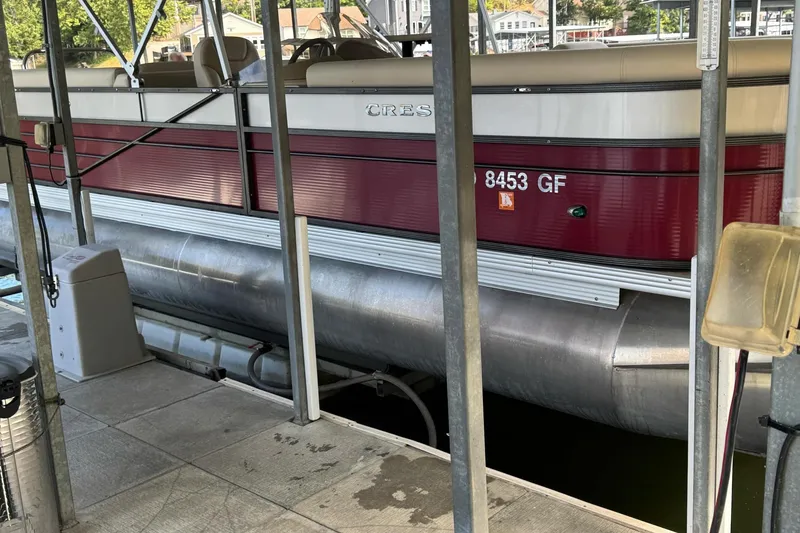 Slide: The Image of 2017 Crest II 250 SLE pontoon boat docked in marina. - 2