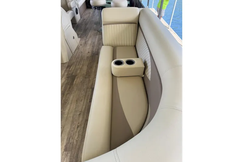Slide: The Image of 2017 Crest II 250 SLE boat interior with beige seating and cup holders. - 4