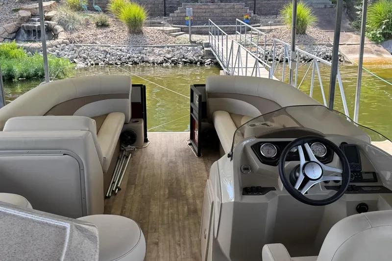 Slide: The Image of Interior of 2017 Crest II 250 SLE pontoon boat with beige seating and steering console. - 6