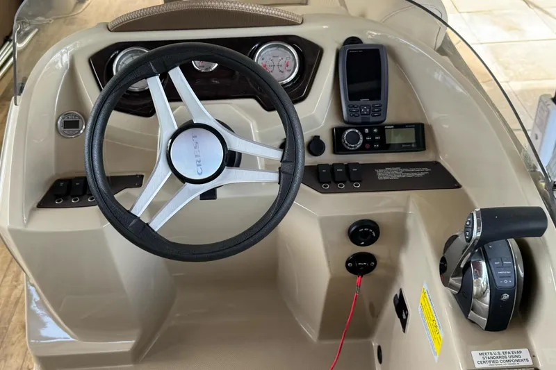 Slide: The Image of Steering console of 2017 Crest II 250 SLE boat with controls and gauges. - 7
