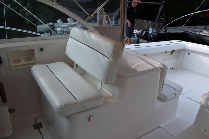 Slide: The Image of 2002 Tiara 2900 Coronet boat interior with white seating and cup holders. - 10