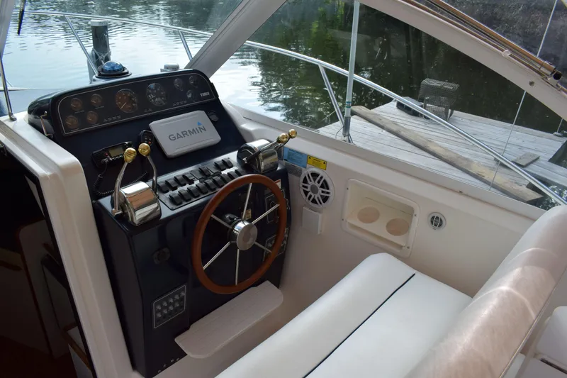 Slide: The Image of 2002 Tiara 2900 Coronet helm with Garmin navigation, docked by water. - 11
