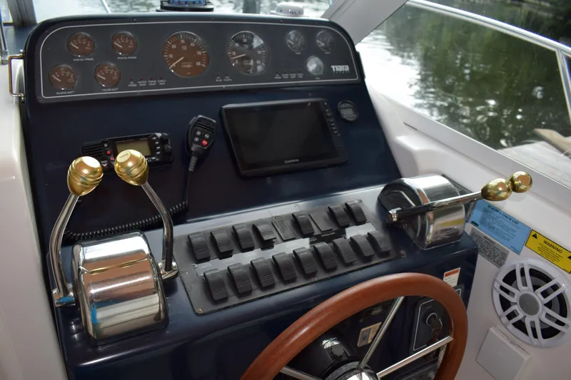 Slide: The Image of 2002 Tiara 2900 Coronet helm with controls, gauges, and steering wheel. - 12