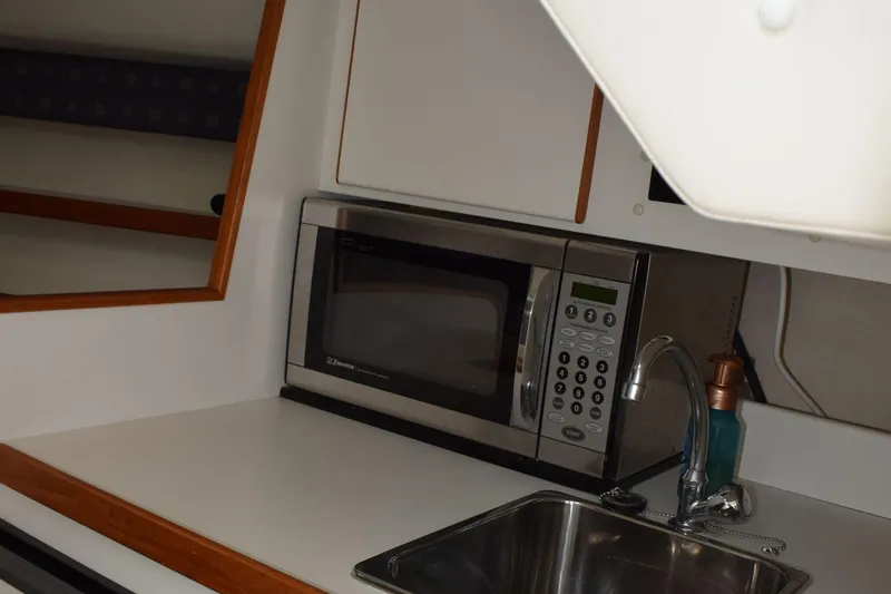 Slide: The Image of 2002 Tiara 2900 Coronet boat kitchen with microwave and sink. - 14