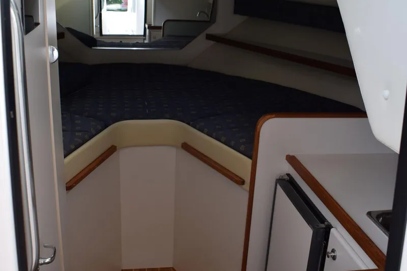 Slide: The Image of 2002 Tiara 2900 Coronet cabin interior with bed and kitchenette. - 15
