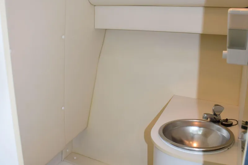 Slide: The Image of 2002 Tiara 2900 Coronet interior with compact sink and minimalist design. - 17