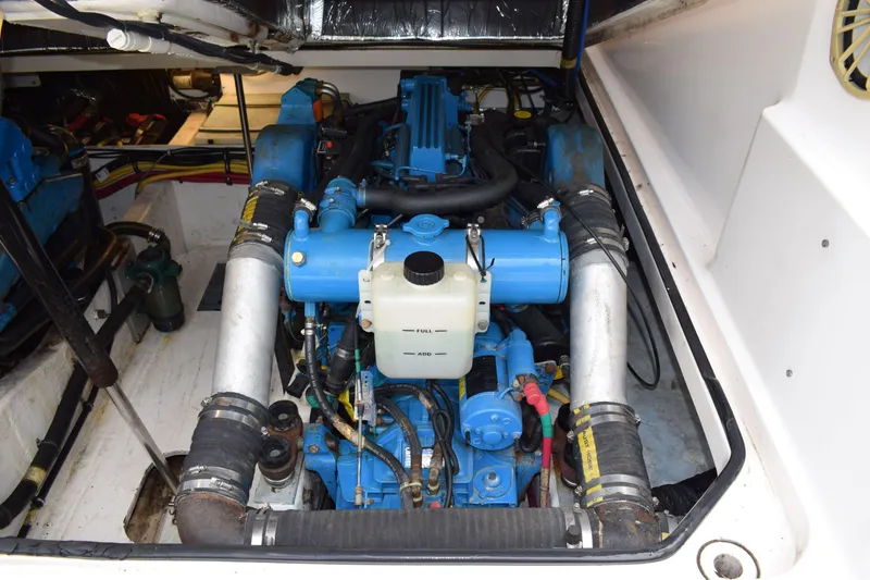 Slide: The Image of Engine compartment of a 2002 Tiara 2900 Coronet boat, showcasing blue engine components. - 22