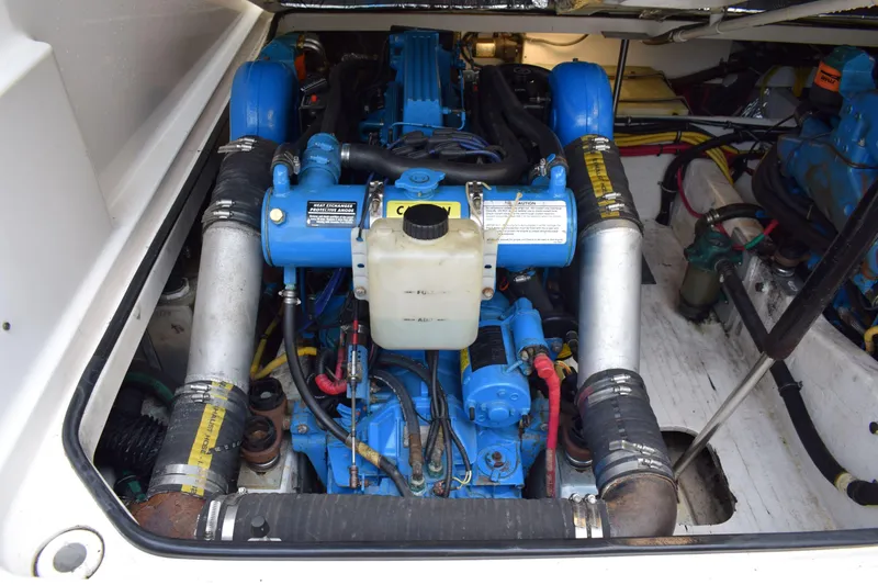 Slide: The Image of Engine compartment of a 2002 Tiara 2900 Coronet boat, showcasing blue engine components. - 23