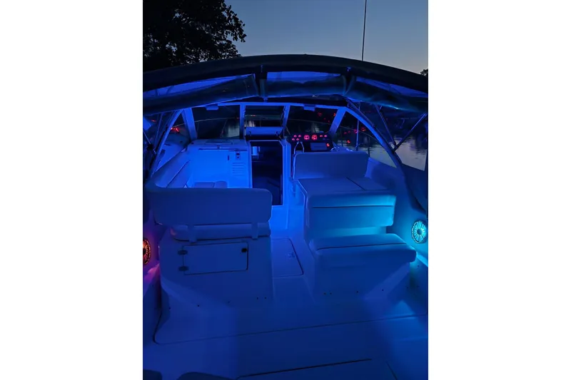Slide: The Image of 2002 Tiara 2900 Coronet boat interior with blue ambient lighting at dusk. - 29