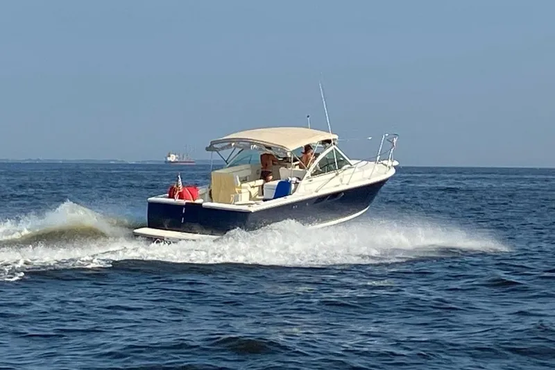 Slide: The Image of 2002 Tiara 2900 Coronet cruising on open water under clear skies. - 31