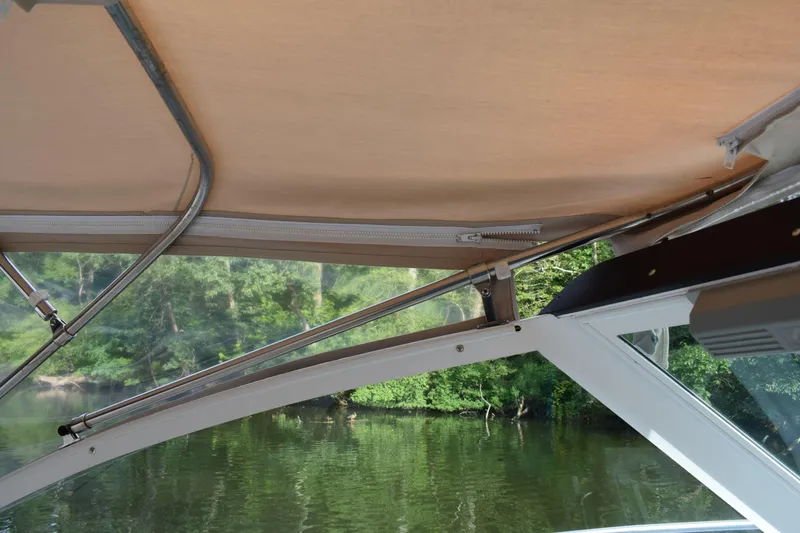 Slide: The Image of 2002 Tiara 2900 Coronet boat canopy with scenic river view. - 4