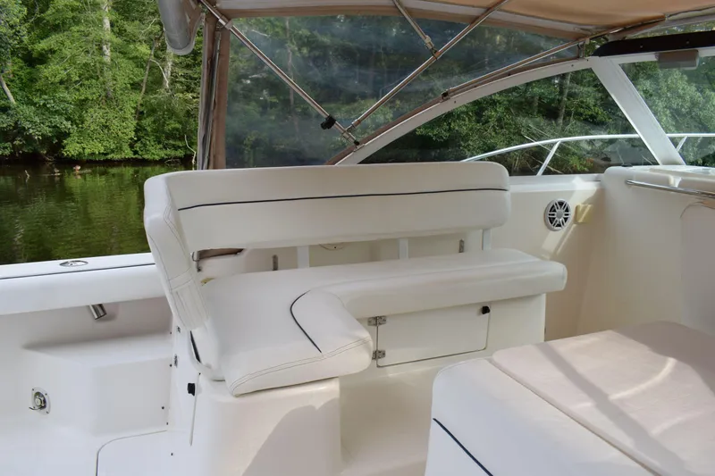 Slide: The Image of 2002 Tiara 2900 Coronet boat interior with white seating and scenic water view. - 5
